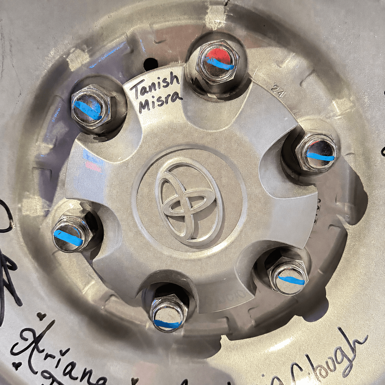 Signing the Toyota wheel cap.