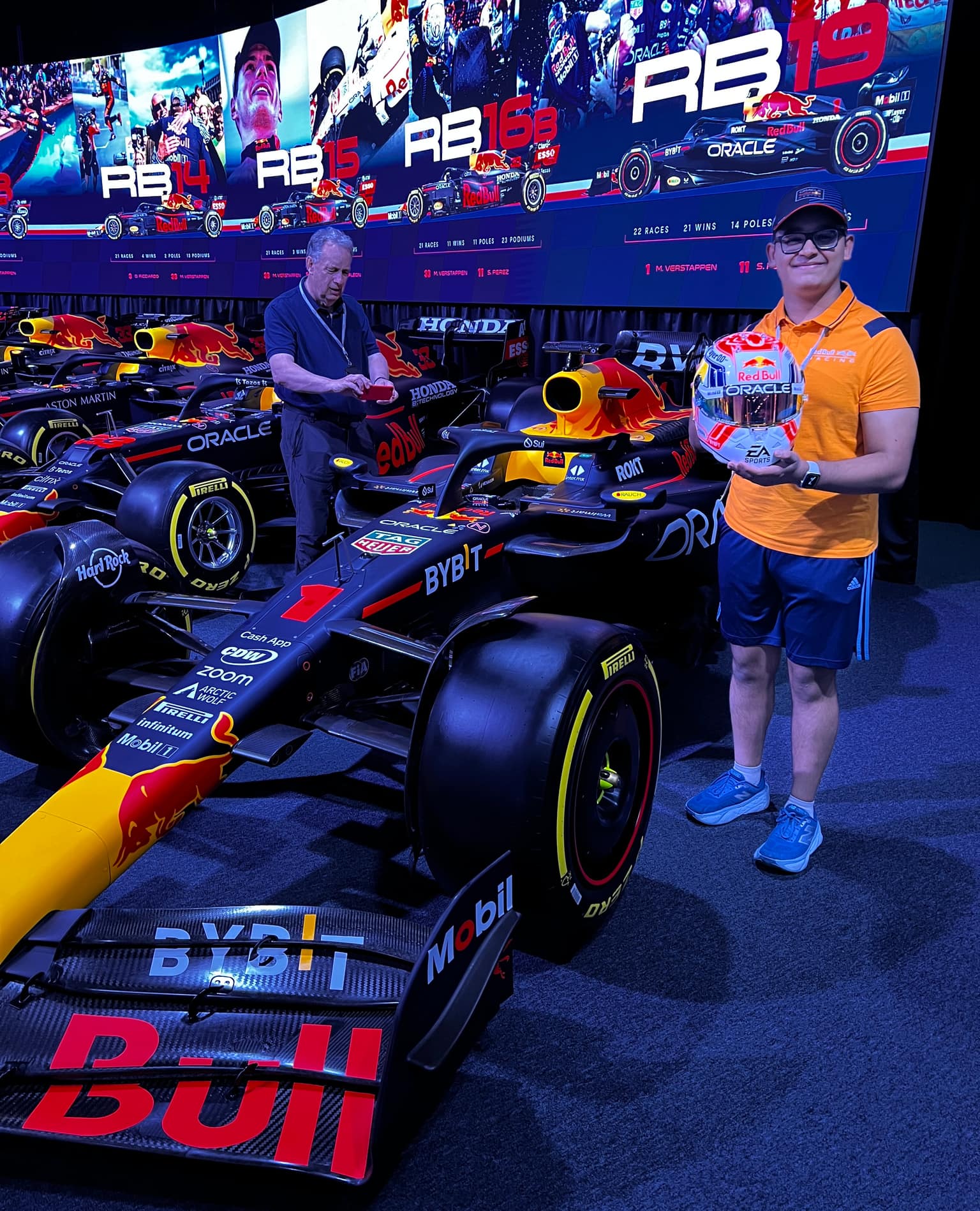 Tanish holding Max Verstappen's helmet alongside the dominant RB19